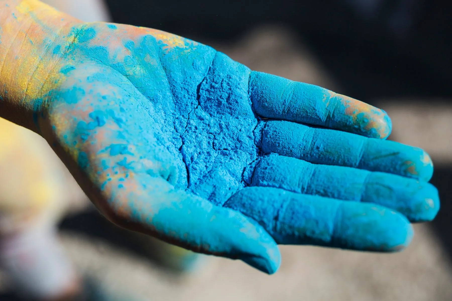 Hand covered in blue powder