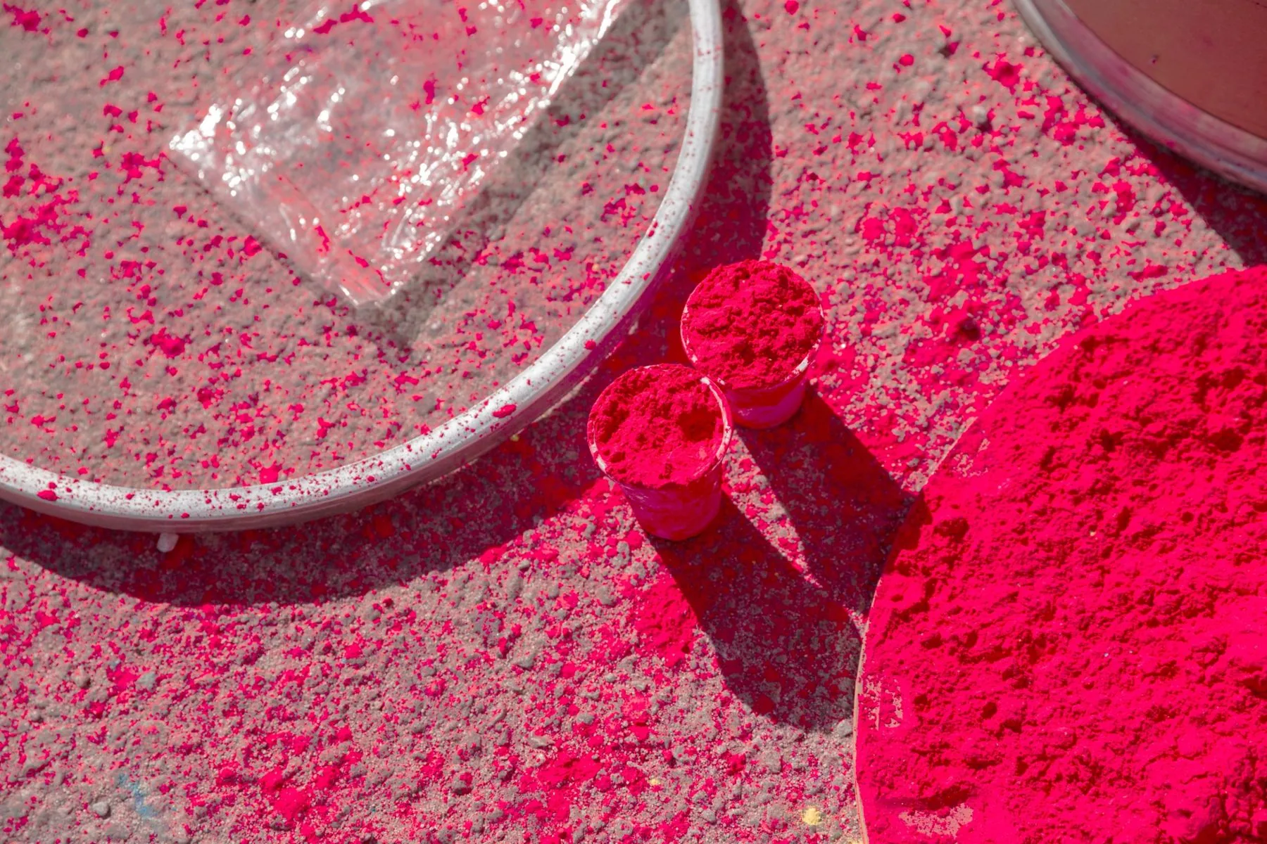 Bright pink powder in cups and piles